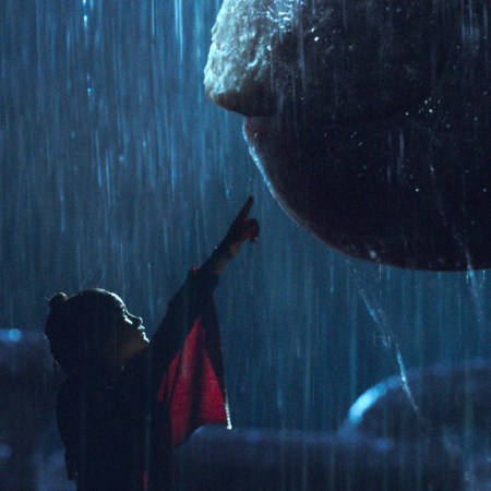 Jia (Kaylee Hottle) reaches towards the giant ape Kong in "Godzilla vs Kong"